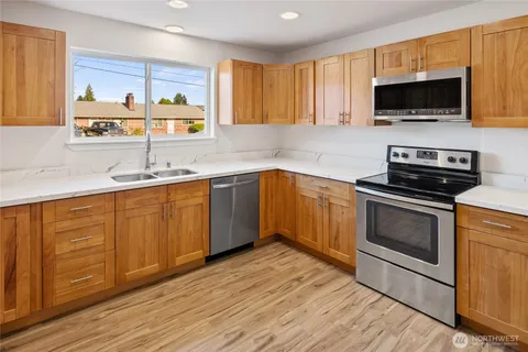 a kitchen with a sink stove and microwave