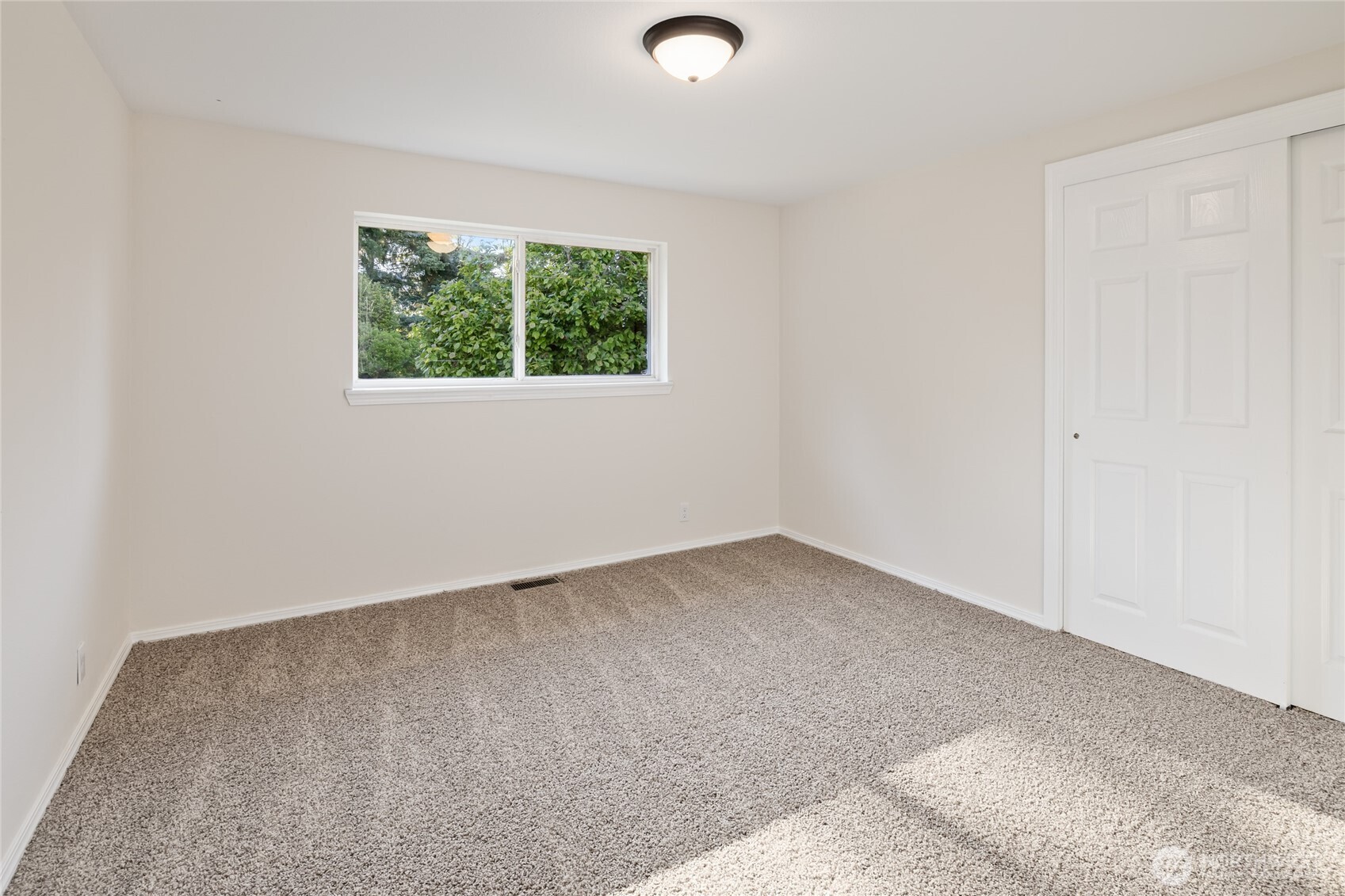 1003 9th Street Northwest Puyallup, WA 98371 - Photo 16 of 40 an empty room with a window