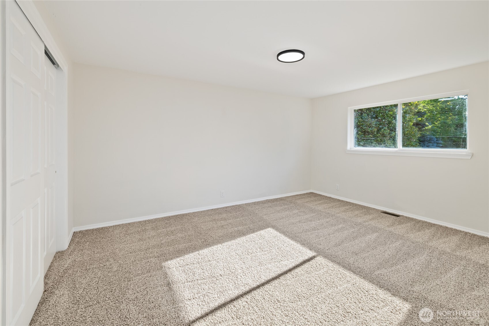 1003 9th Street Northwest Puyallup, WA 98371 - Photo 18 of 40 an empty room with a window