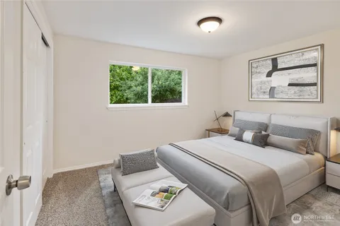 a bedroom with a bed and glass window