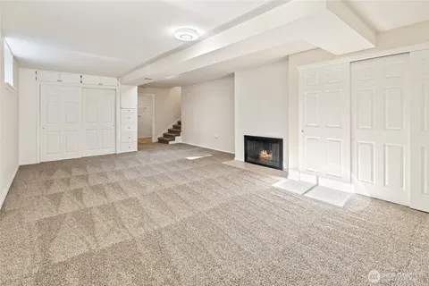 a view of empty room with a fireplace