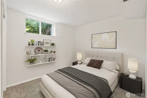 a bedroom with a bed and a painting on the wall