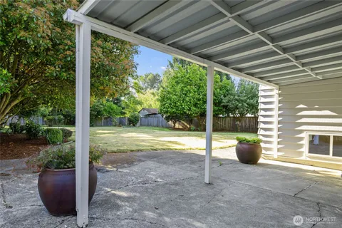 a view of a porch with furniture and garden