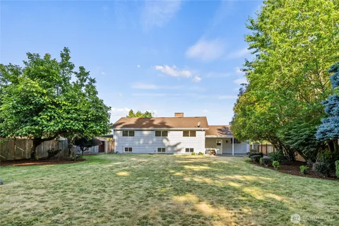 a aerial view of a house with a yard table and chairs