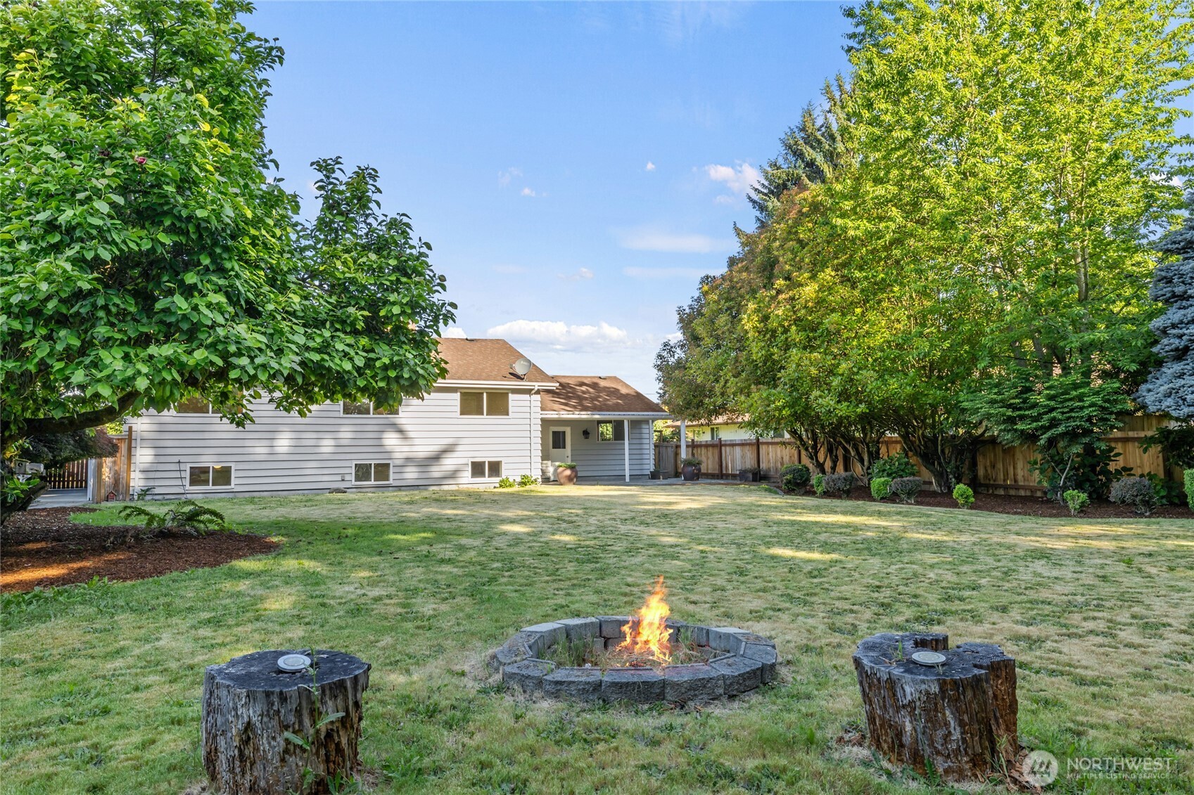 1003 9th Street Northwest Puyallup, WA 98371 - Photo 35 of 40 a view of a house with backyard and sitting area