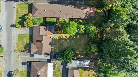 an aerial view of a house with a yard and garden