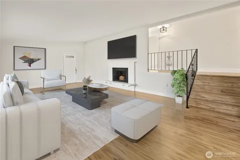 a living room with furniture floor to ceiling window and a fireplace