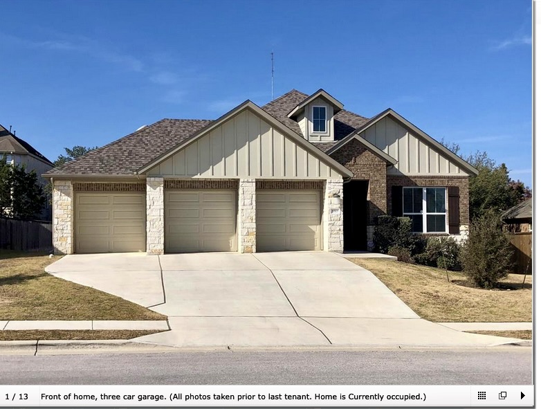 8813 Moccasin Path Austin, TX 78736 - Photo 1 of 10 View of front of home featuring board and batten siding, a 3 car garage, a shingled roof, and driveway