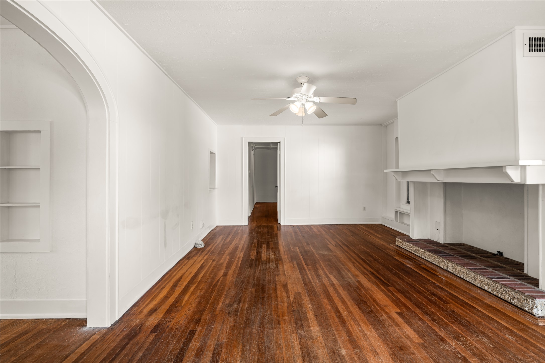 2202 West Main Street Houston, TX 77098 - Photo 2 of 32 a view of empty room with wooden floor and fan