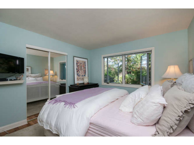 167 Springdale Way Redwood City, CA 94062 - Photo 22 of 25 a bedroom with a bed and a flat tv screen