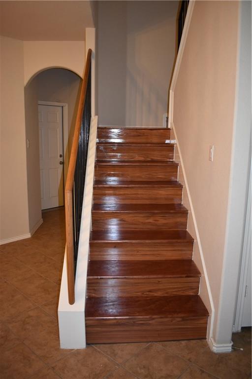 1310 West Parmer Lane, Unit 1503 Austin, TX 78727 - Photo 10 of 26 Staircase featuring arched walkways and tile patterned floors