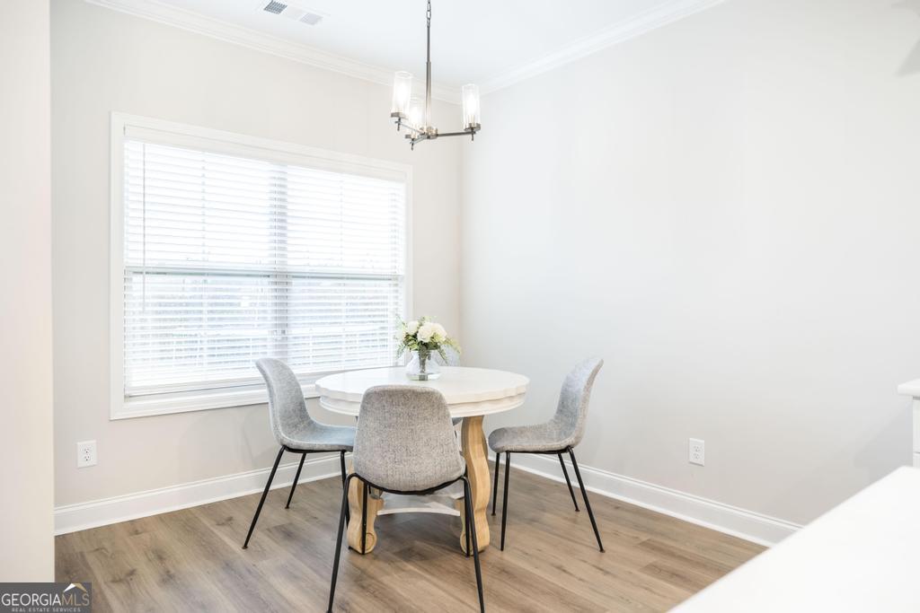 111 Fieldview Lane Kathleen, GA 31047 - Photo 11 of 36 a view of a dining room with furniture window and wooden floor