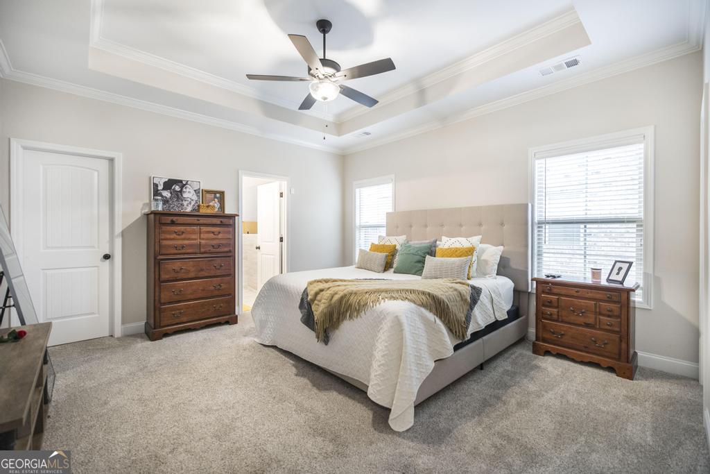 111 Fieldview Lane Kathleen, GA 31047 - Photo 16 of 36 a spacious bedroom with a bed a dresser and a ceiling fan