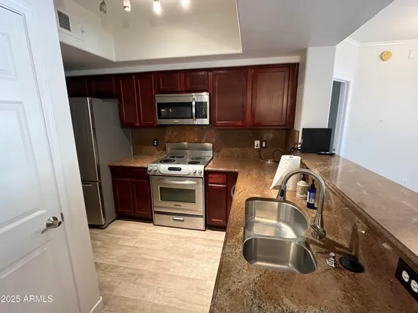 a kitchen with a stove microwave and refrigerator