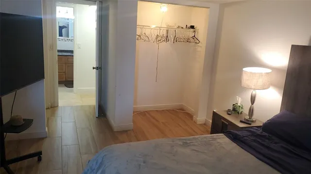 a bedroom with a bed and a lamp on table