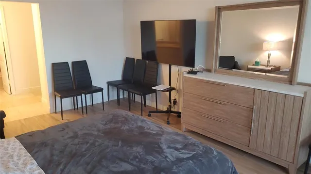 a bedroom with a bed and chair