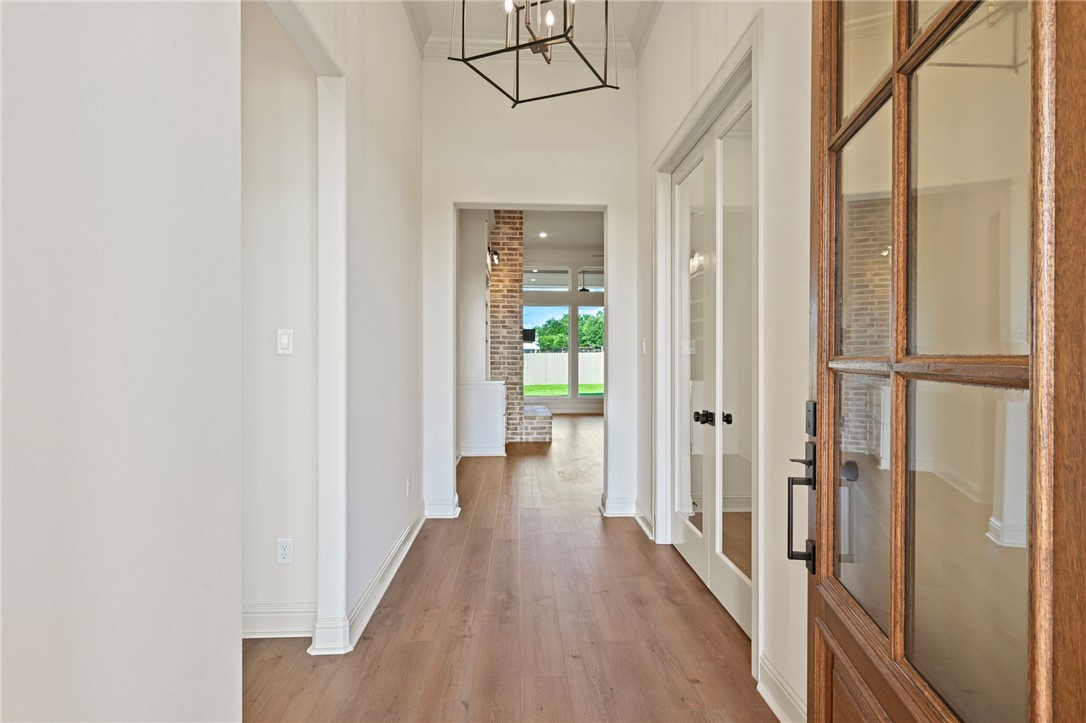 7052 Skipping Rock Path Bryan, TX 77808 - Photo 2 of 23 a view of a hallway with wooden floor and staircase