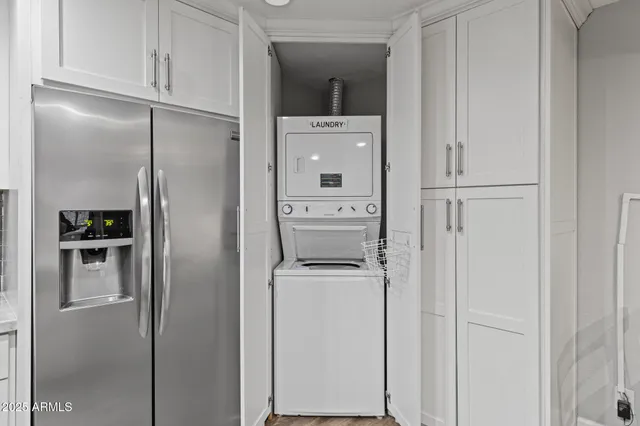 a kitchen with a refrigerator and cabinets