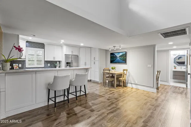 a kitchen with a table and chairs in it