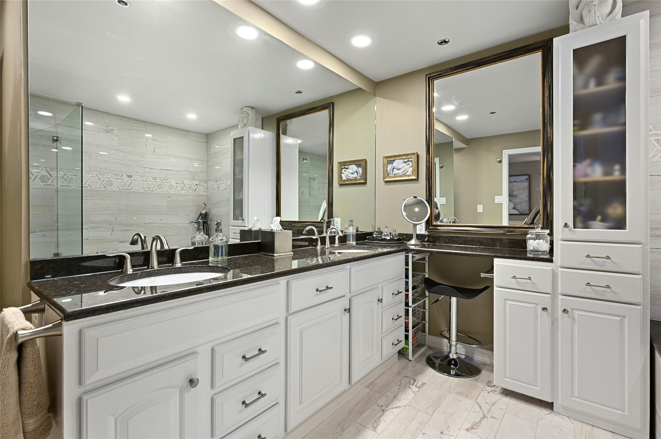 40 North Interstate Highway 35, Unit 8C1 Austin, TX 78701 - Photo 9 of 36 Spacious primary bathroom boasting a dual vanity, large mirror, vanity area, and ample cabinets for storage, combining functionality with style for your daily routine.