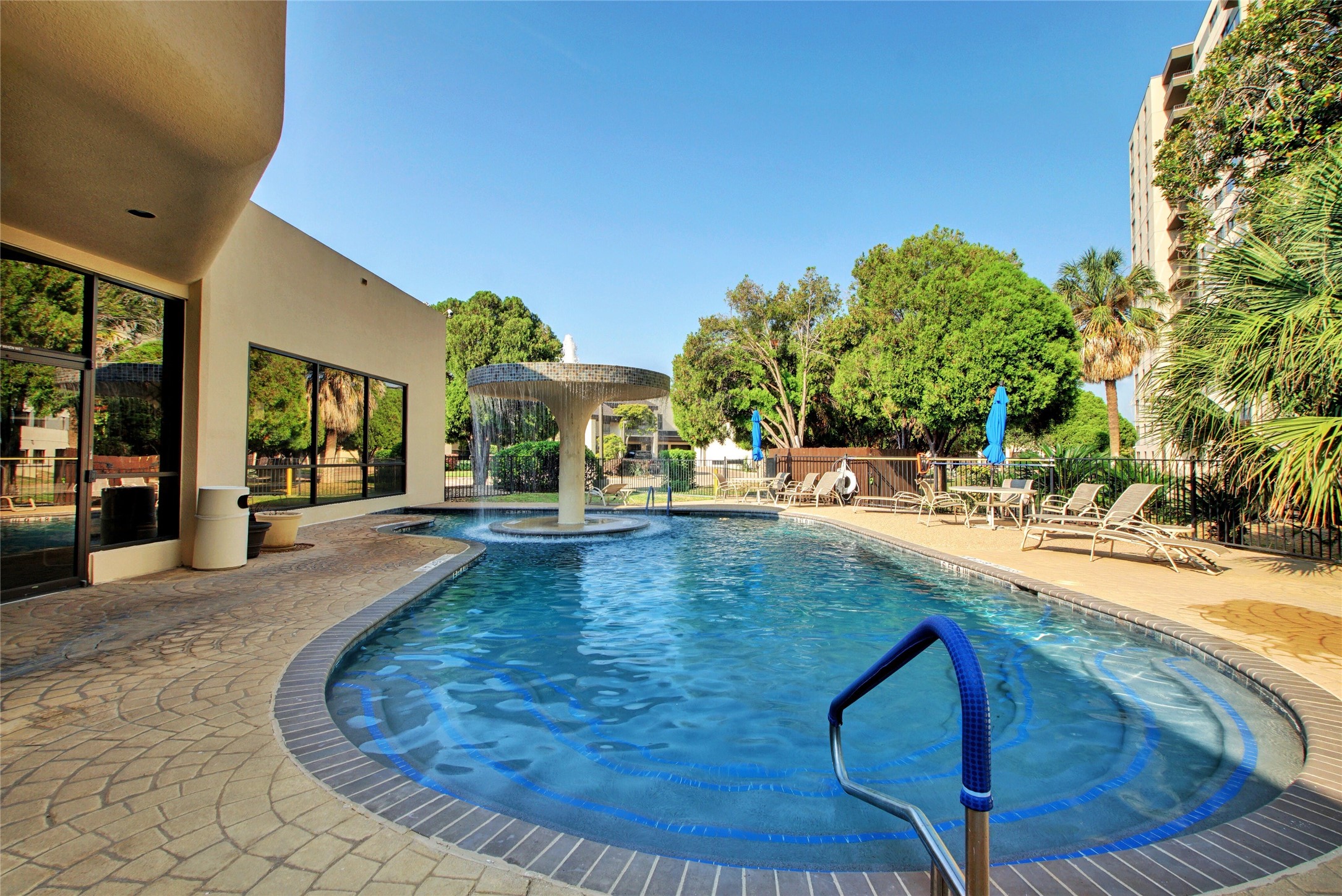 40 North Interstate Highway 35, Unit 8C1 Austin, TX 78701 - Photo 26 of 36 Bask in the sun by a serene outdoor pool, lounging in bliss.