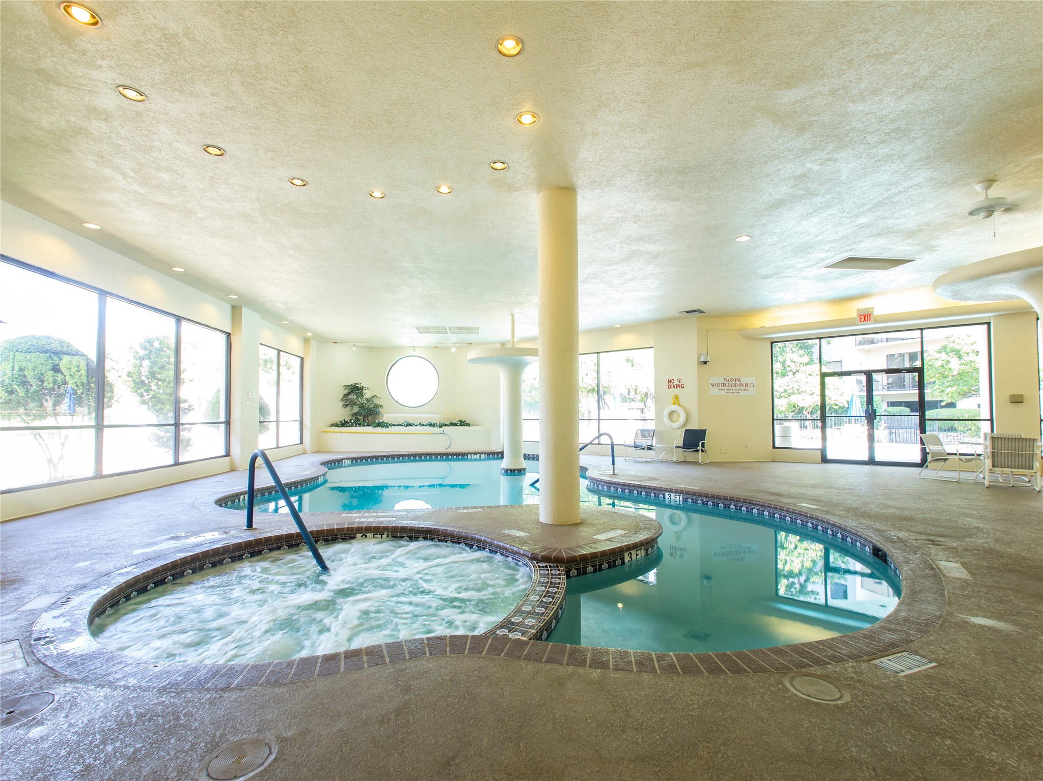 40 North Interstate Highway 35, Unit 8C1 Austin, TX 78701 - Photo 28 of 36 As you explore the serene indoor pool area, you discover a seamless transition that leads you to an enchanting outdoor pool. The spa's tranquil atmosphere extends to the outdoor space, where you can continue your relaxation journey.