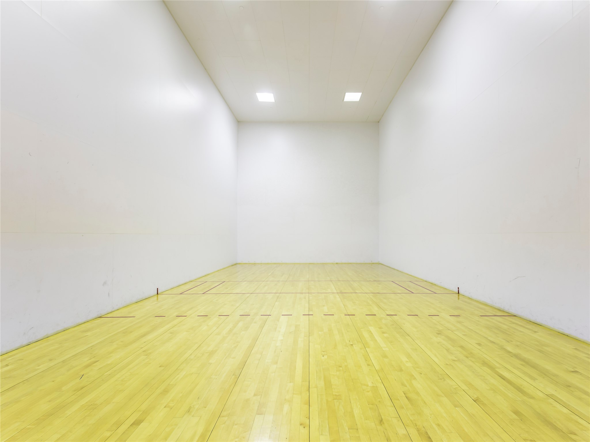 40 North Interstate Highway 35, Unit 8C1 Austin, TX 78701 - Photo 31 of 36 Step into an expansive indoor tennis facility that promises excitement and athletic prowess. The spacious indoor court awaits, bathed in bright lighting that illuminates the pristine surface.