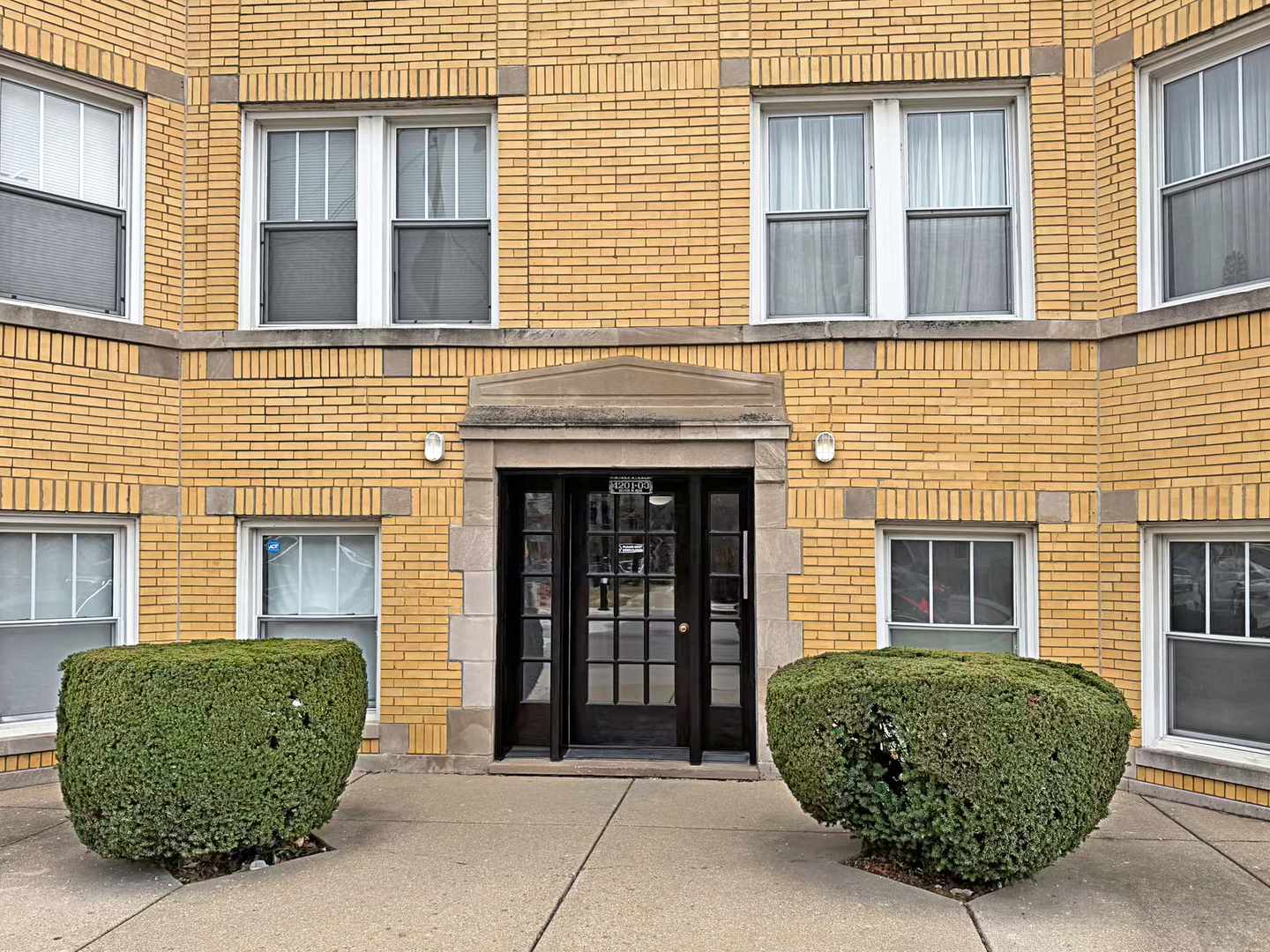 4201 West Addison Street, Unit 2B Chicago, IL 60641 - Photo 2 of 16 front view of a brick house with a window