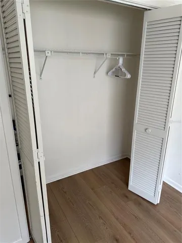 a view of walk in closet with wooden floor