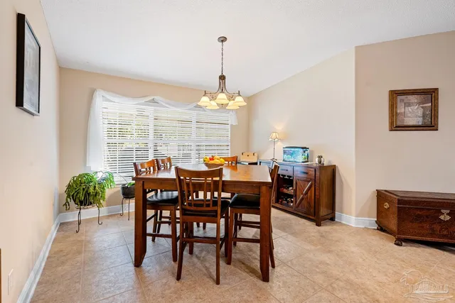 a view of a dining room and livingroom with furniture window and a chandelier