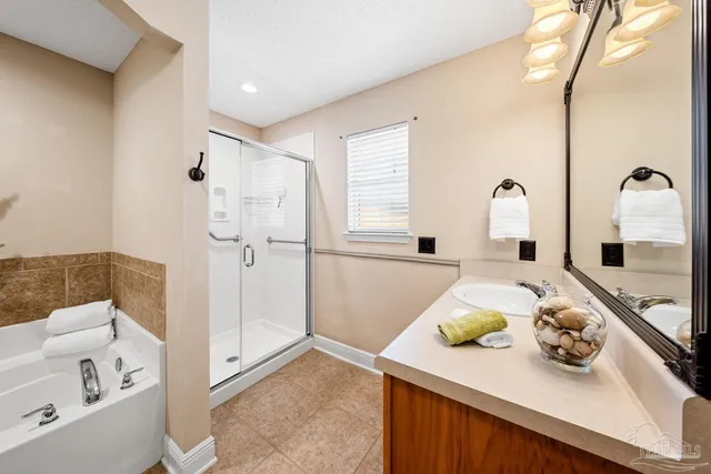 a spacious bathroom with a tub shower and a sink