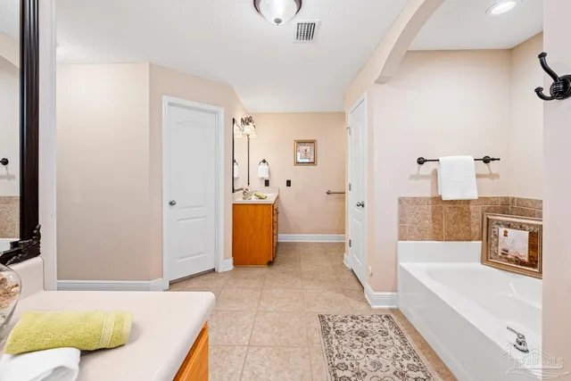 a bathroom with a tub shower and a sink