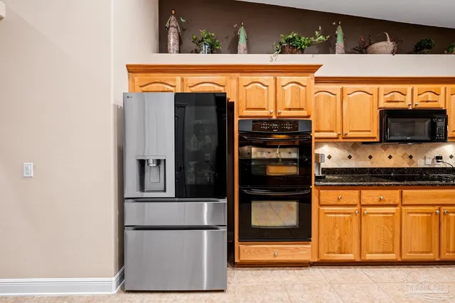 a large white kitchen with a stove a sink and a refrigerator