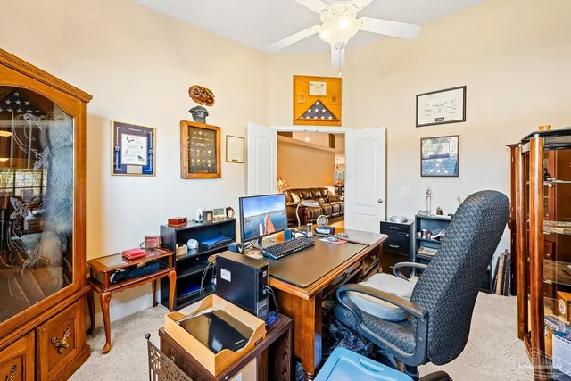 a reading room with furniture a rug and a window