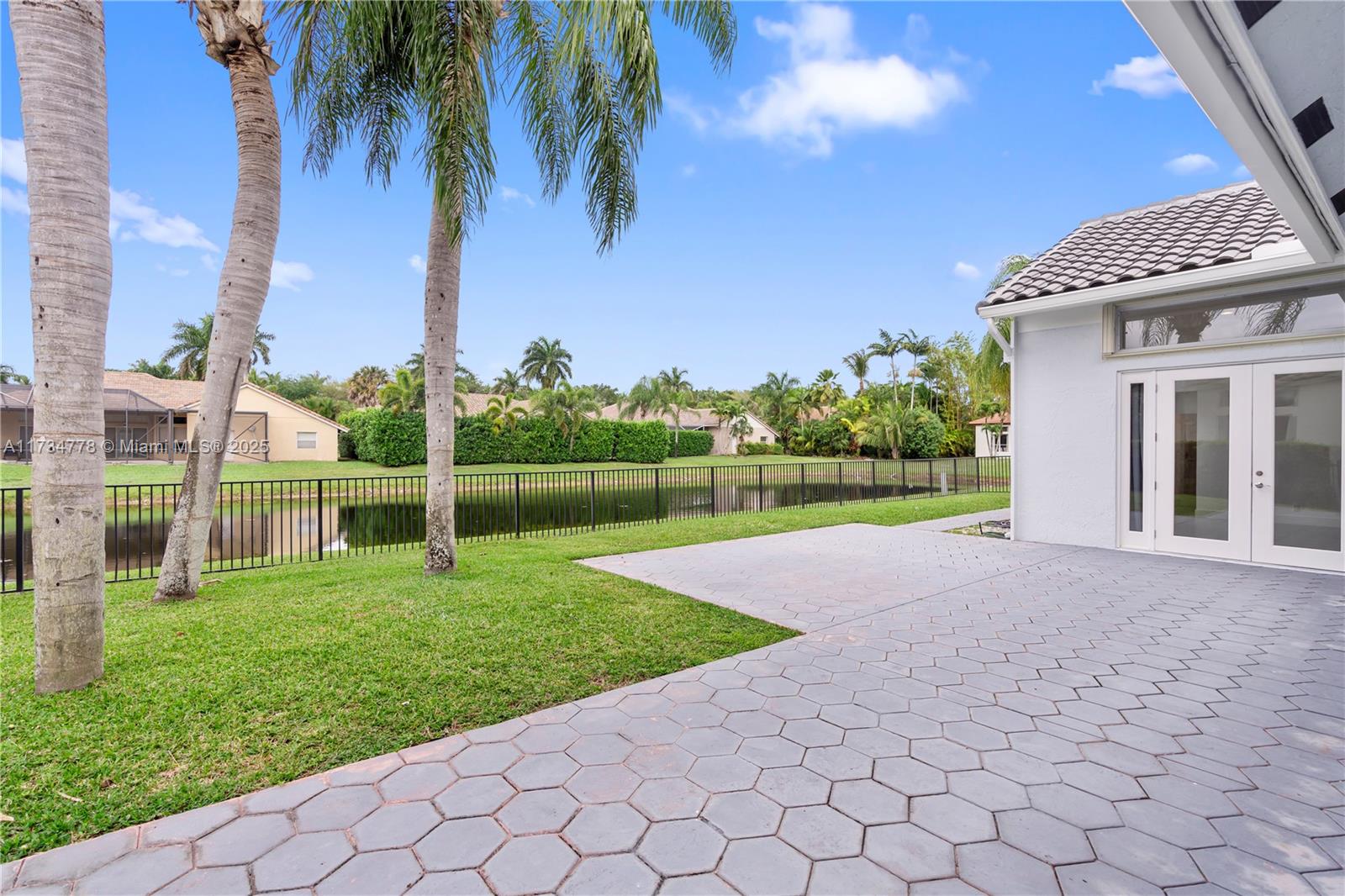 10575 East Key Drive Boca Raton, FL 33498 - Photo 46 of 67 a view of a house with a yard and potted plants