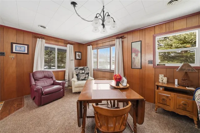 a living room with furniture a window and a flat screen tv