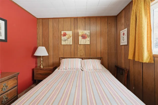 a view of a bedroom with wooden floor and stairs