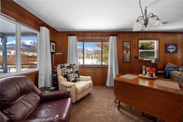 a bedroom with furniture and a large window