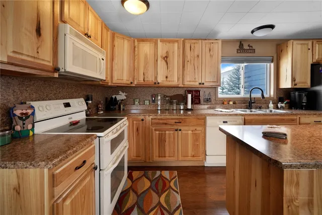 a kitchen that has a sink and a stove
