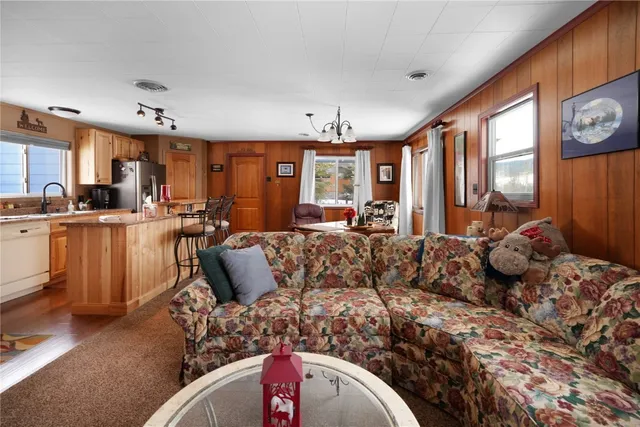 a living room with furniture fireplace and a large window