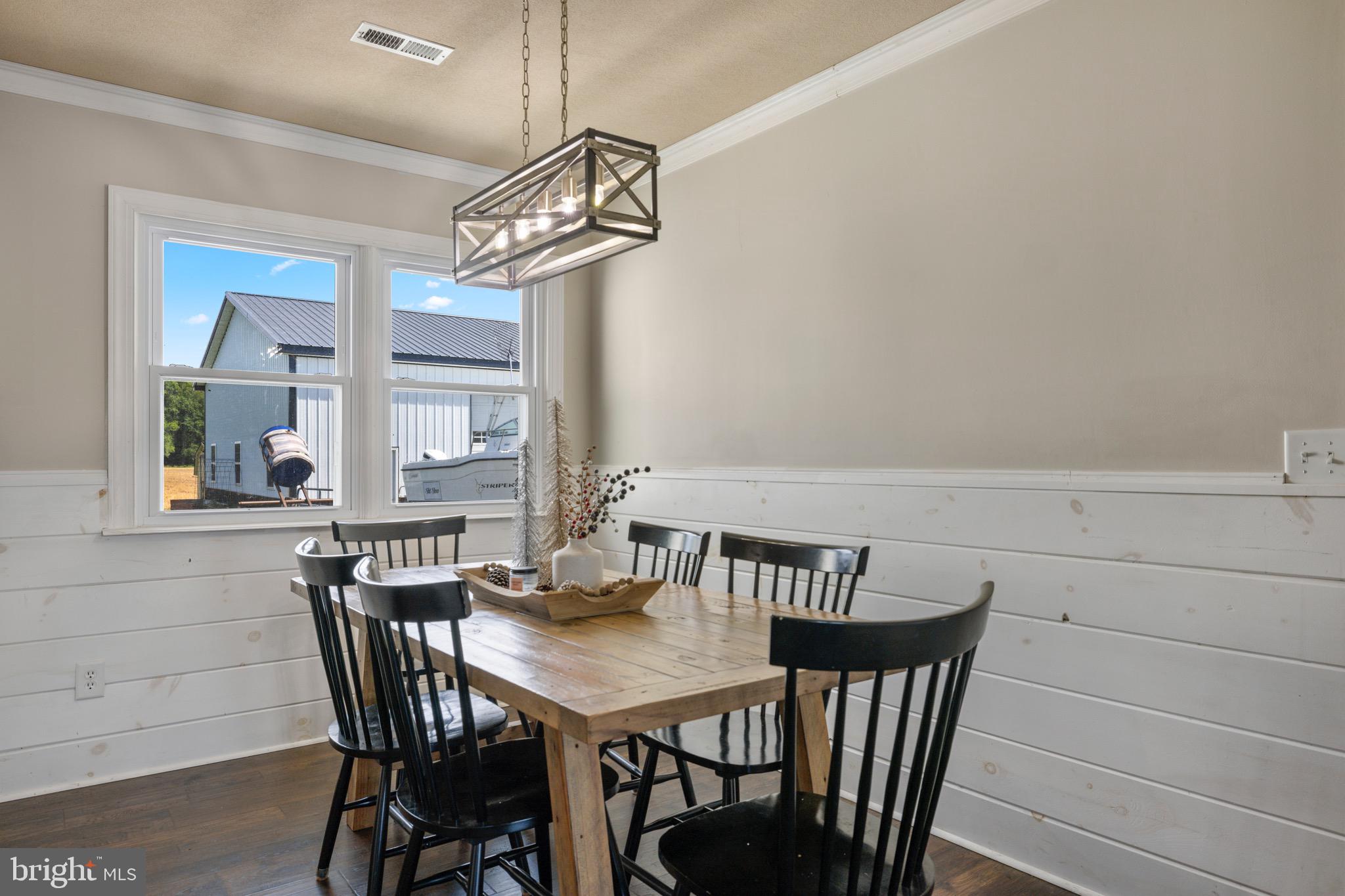 25612 Auction Road Federalsburg, MD 21632 - Photo 50 of 71 a view of a dining room with furniture and a chandelier
