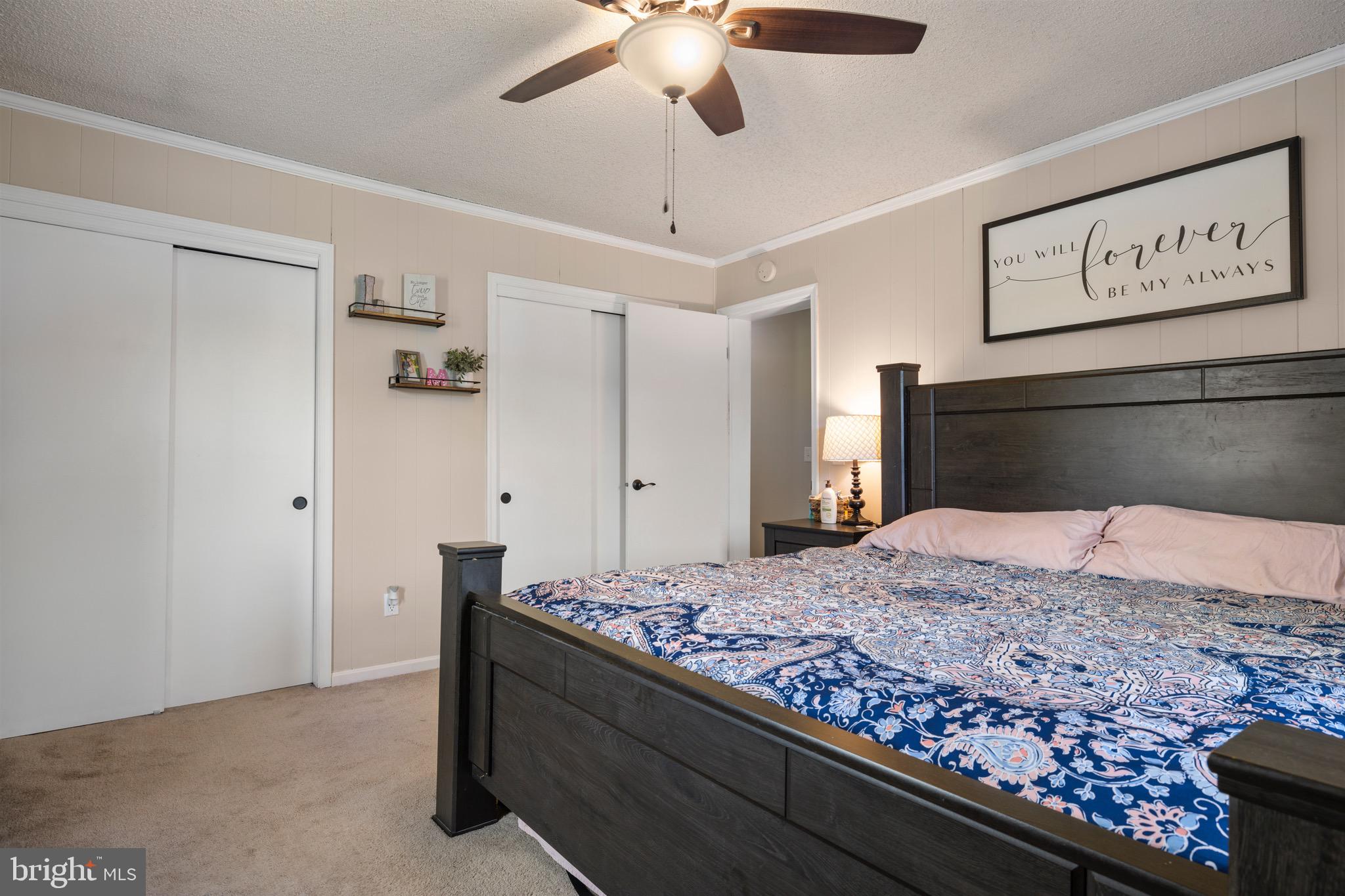 25612 Auction Road Federalsburg, MD 21632 - Photo 54 of 71 a bedroom with a bed and a chandelier