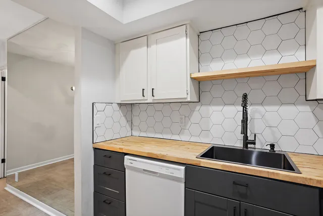 a view of a kitchen with a sink and cabinets