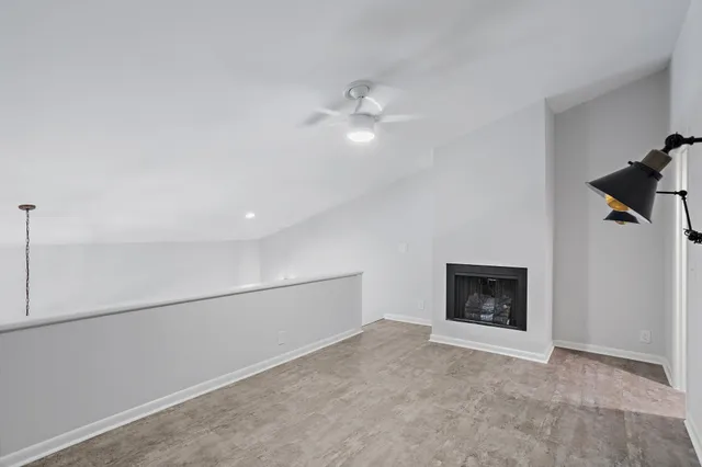 a view of an empty room with fire place
