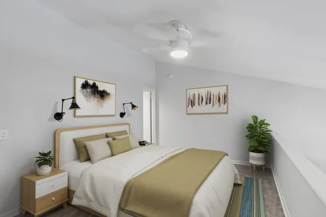 a bedroom with a bed and a potted plant