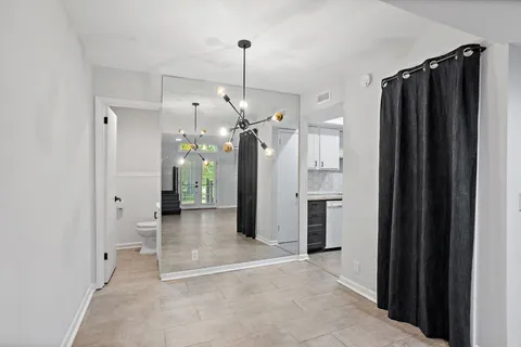 a view of a kitchen with a refrigerator and a sink
