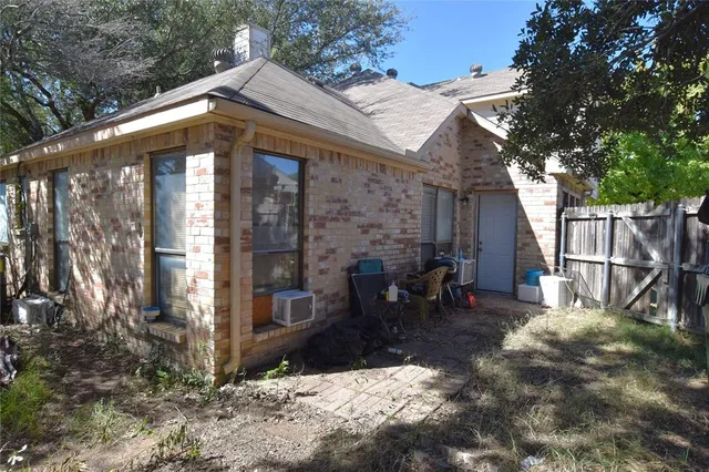 a view of a house with a yard and large tree