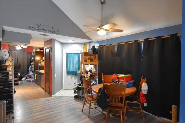 a dining room with furniture window and wooden floor