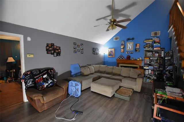 a living room with furniture or couch and a wooden floor