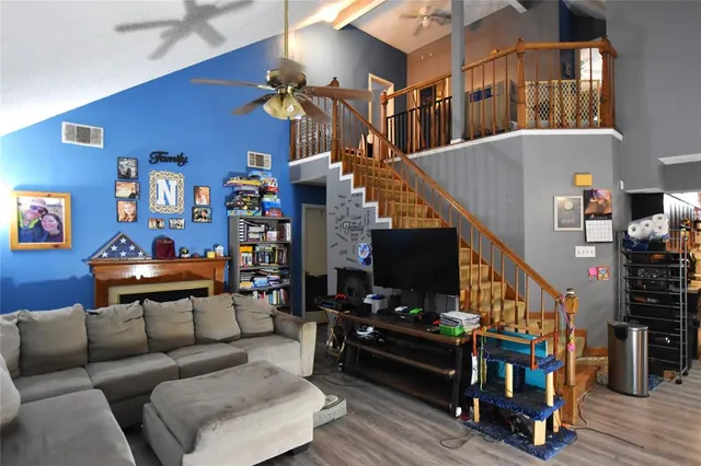 a living room with furniture and wooden floor